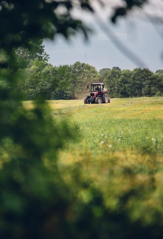 selective-focus-shot-of-a-tractor-in-a-yellow-and-2023-11-27-04-55-45-utc